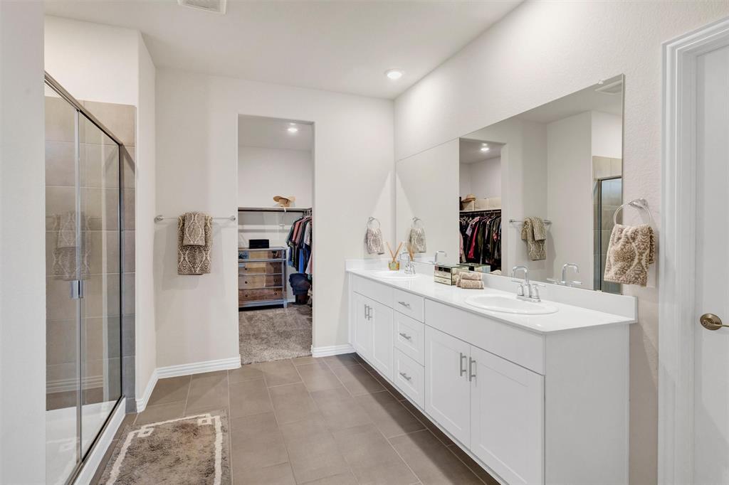 10616 Brookshire Road Fort Worth, TX 76126 - Photo 13 of 29 Double vanities, a separate toilet room, large walk in shower and huge walk in closet in the primary suite.