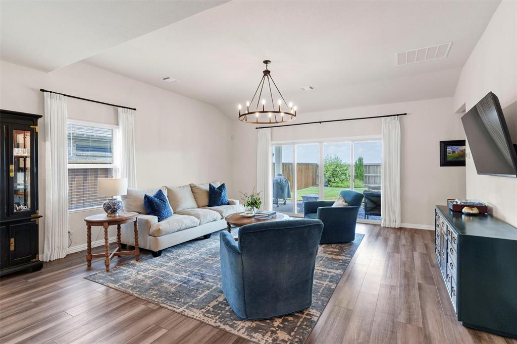 10616 Brookshire Road Fort Worth, TX 76126 - Photo 8 of 29 Spacious living room with upgraded light fixtures and drapes- sliding glass doors open directly to your huge patio and beautifully landscaped backyard with no back neighbors