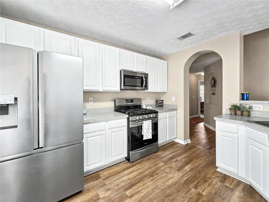209 Diamond Valley Pass Canton, GA 30114 - Photo 12 of 27 a kitchen with a refrigerator stove and sink