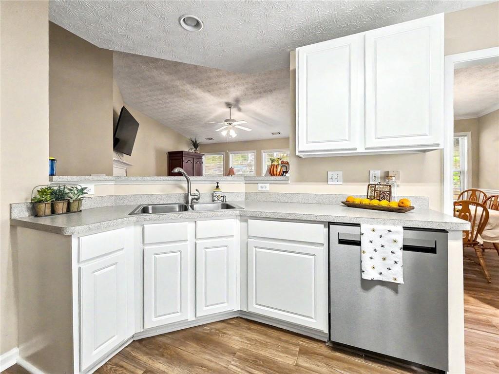 209 Diamond Valley Pass Canton, GA 30114 - Photo 13 of 27 a kitchen with granite countertop white cabinets and white appliances