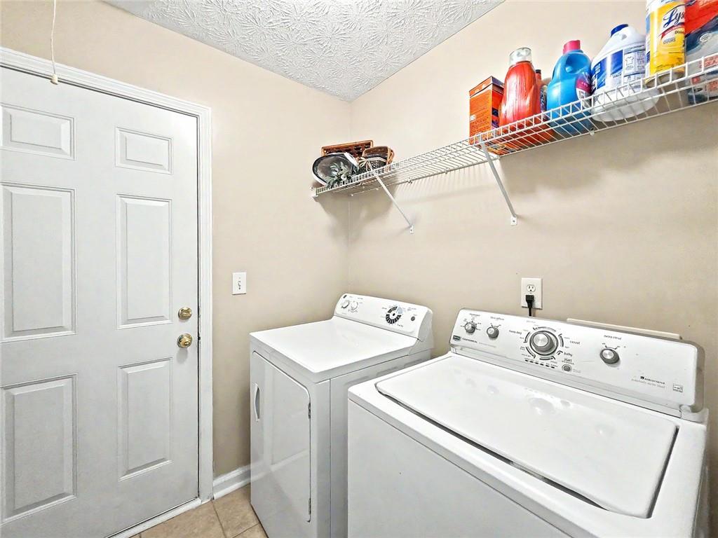 209 Diamond Valley Pass Canton, GA 30114 - Photo 15 of 27 a utility room with dryer and washer