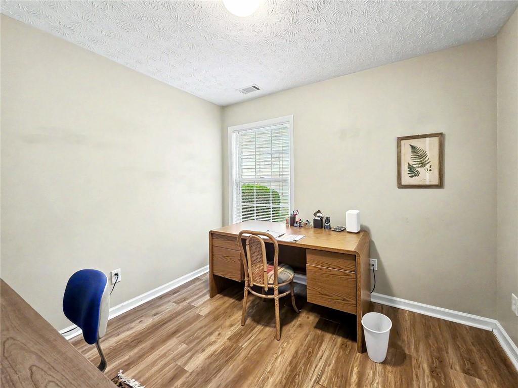 209 Diamond Valley Pass Canton, GA 30114 - Photo 16 of 27 a view of a workspace with furniture and a window