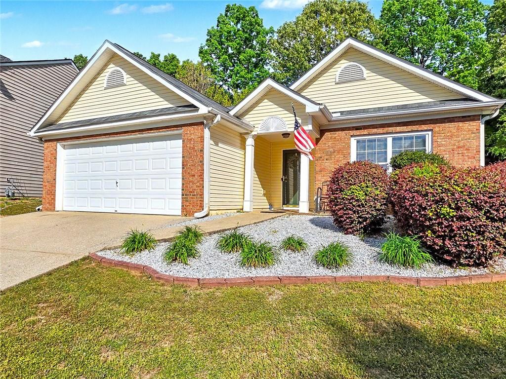 209 Diamond Valley Pass Canton, GA 30114 - Photo 2 of 27 a front view of a house with garden