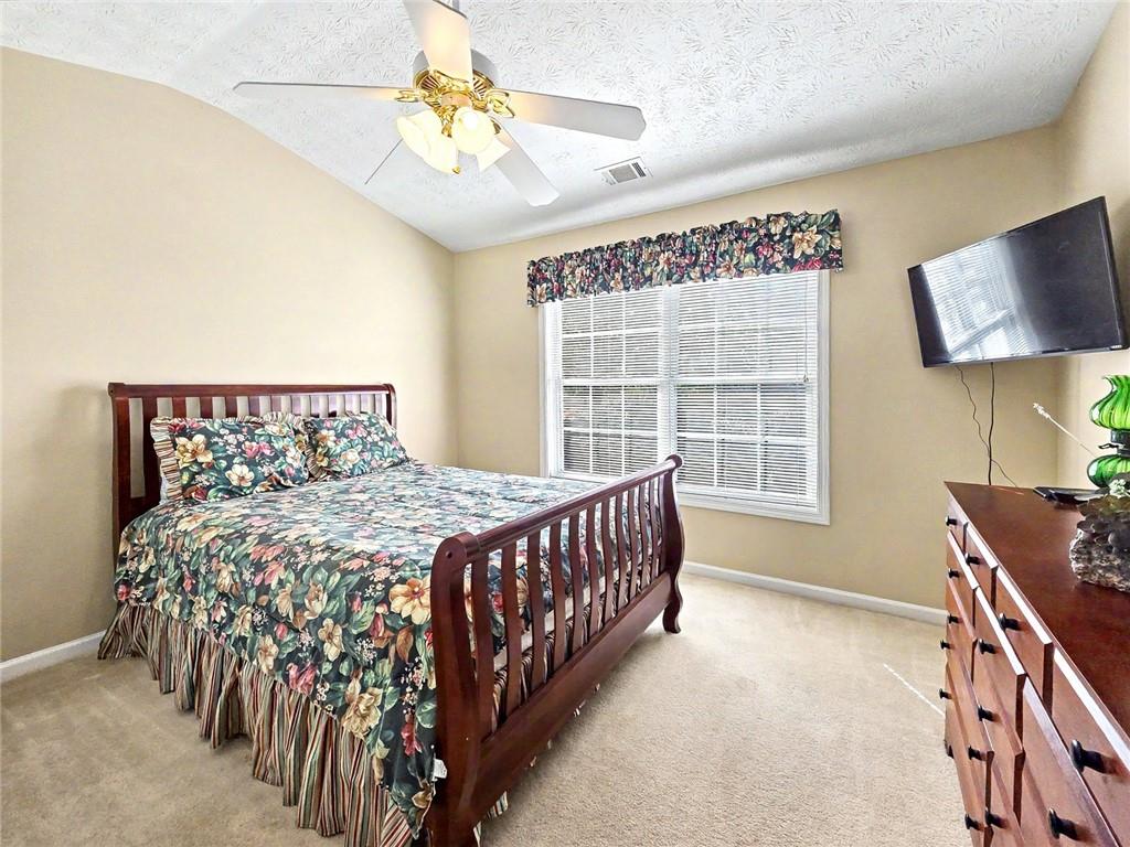 209 Diamond Valley Pass Canton, GA 30114 - Photo 21 of 27 a bedroom with a bed and a window