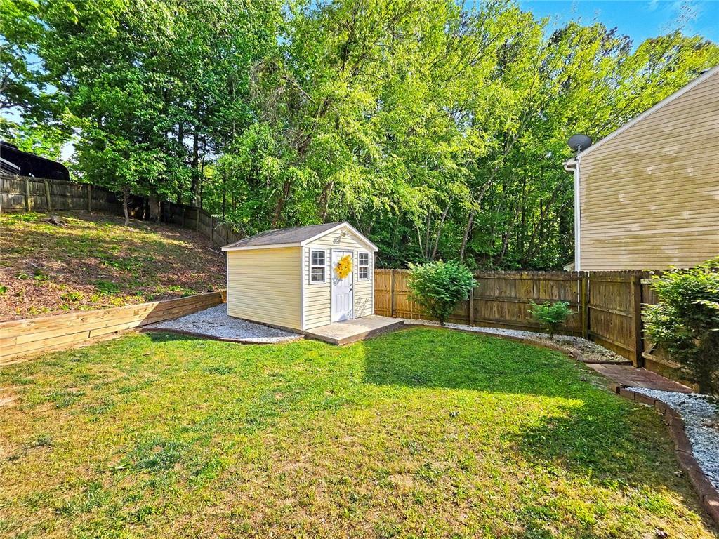 209 Diamond Valley Pass Canton, GA 30114 - Photo 25 of 27 a backyard of a house with plants and large trees