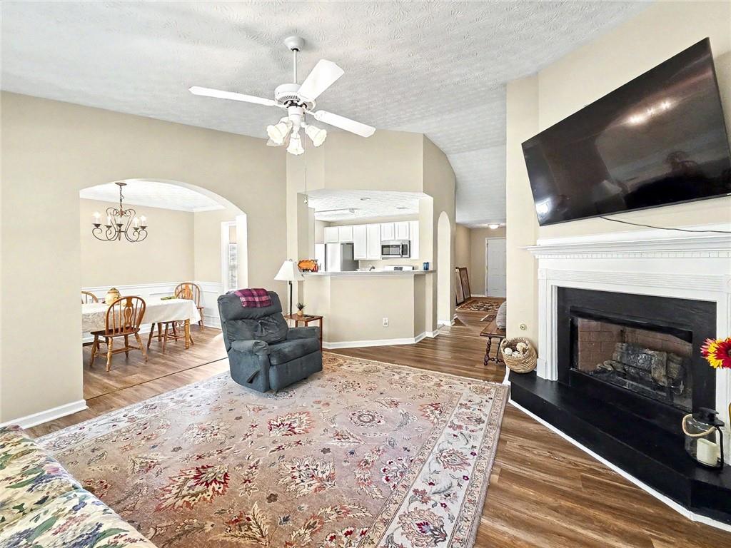 209 Diamond Valley Pass Canton, GA 30114 - Photo 7 of 27 a living room with furniture a flat screen tv and a fireplace