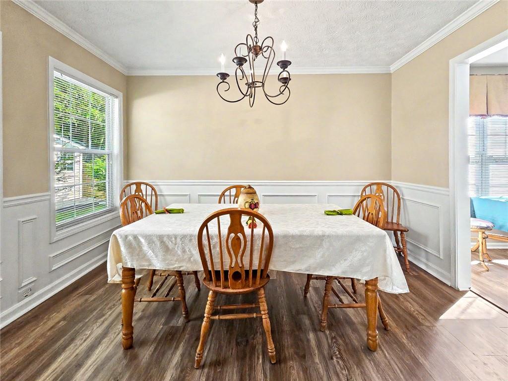 209 Diamond Valley Pass Canton, GA 30114 - Photo 8 of 27 a view of a dining room with furniture window and wooden floor