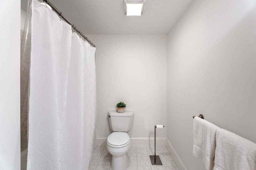 296 West 3rd Street, Unit U1 Boston, MA 02127 - Photo 12 of 22 a white toilet sitting next to a shower