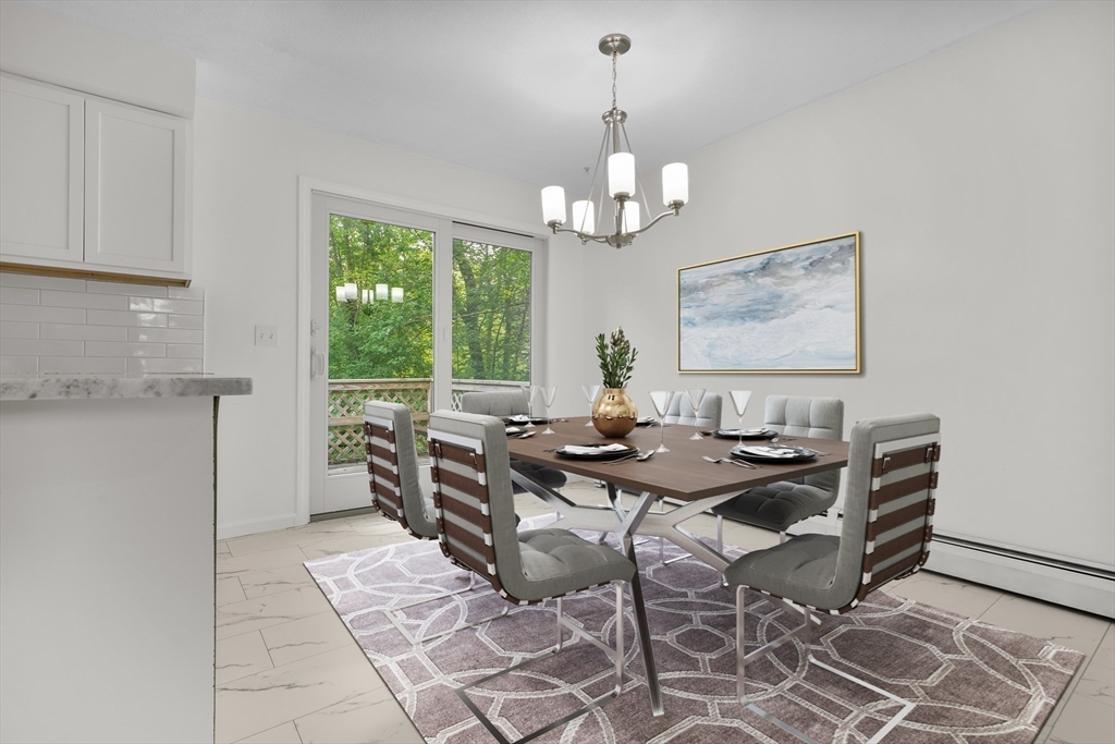 90 Merlin Drive Swansea, MA 02777 - Photo 3 of 13 a view of a dining room with furniture a chandelier and wooden floor