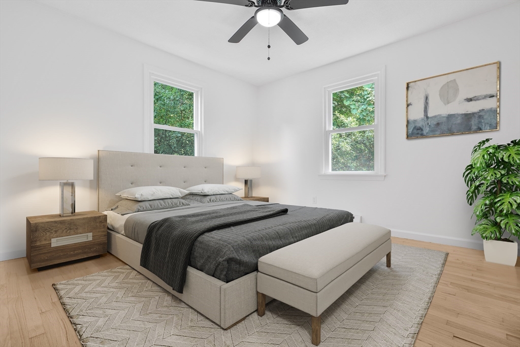 90 Merlin Drive Swansea, MA 02777 - Photo 5 of 13 a bedroom with a large bed and a chandelier