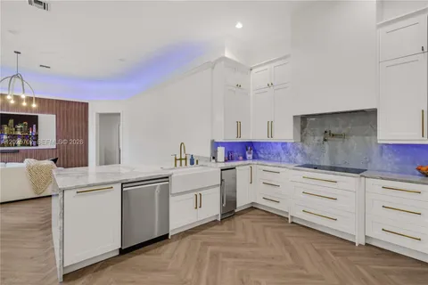 a kitchen with stainless steel appliances a refrigerator and a stove top oven