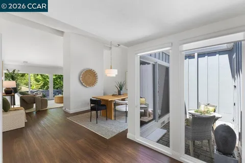 a living room with furniture a window and wooden floor