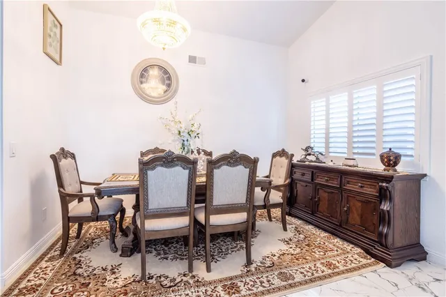 a view of a dining room with furniture and a large window