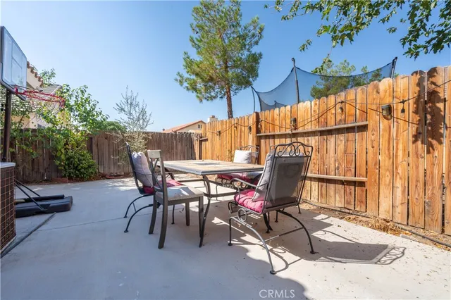 a view of backyard with a table and chairs