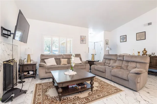 a living room with furniture a rug and a window