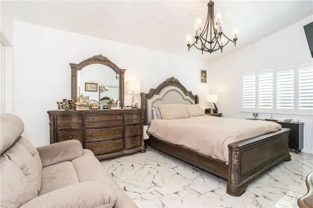 a bedroom with a bed and a chandelier