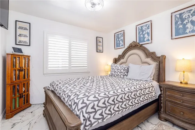 a bedroom with a large bed and a window