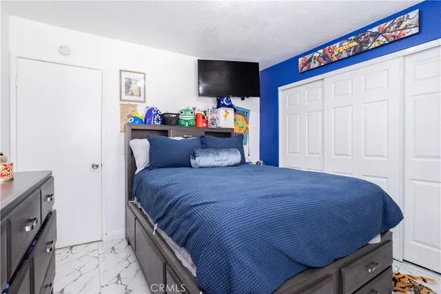 a bedroom with a bed and a flat screen tv