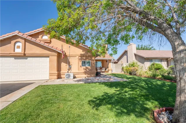 a view of a house with a yard and sitting area