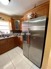 a kitchen with a refrigerator and window