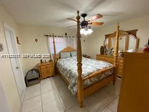 a bedroom with a bed and ceiling fan