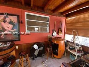 a room with furniture and musical instruments