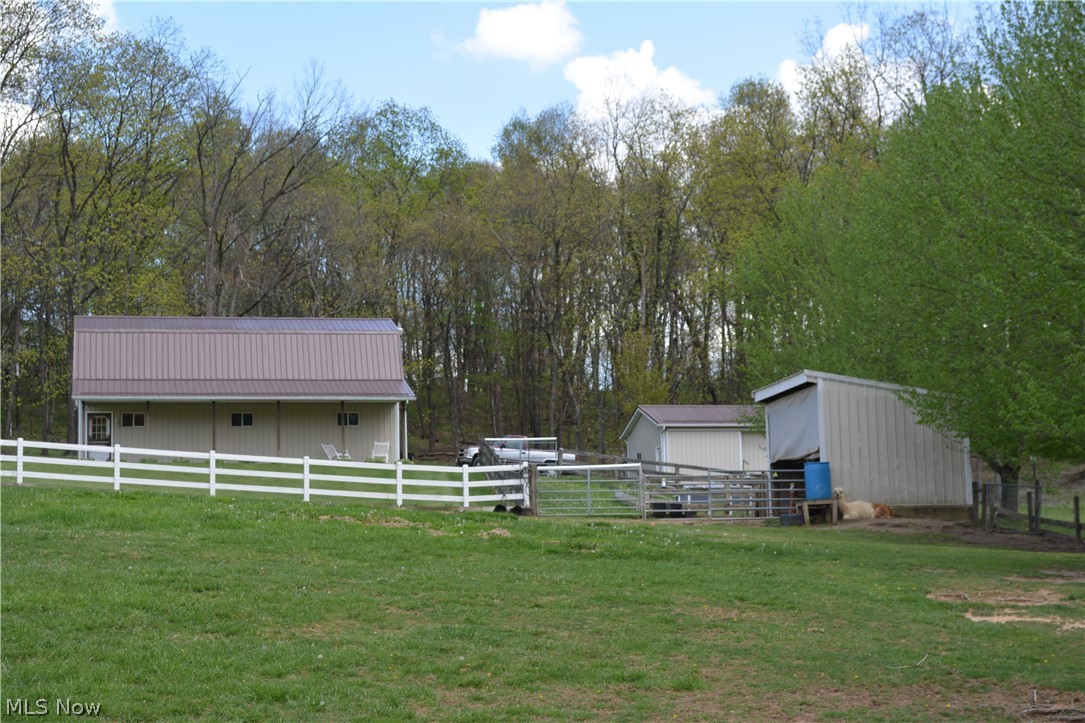 2363 Tabor Ridge Road Northeast New Philadelphia, OH 44663 - Photo 8 of 42 Pastureland featuring a white rail fence and multiple outbuildings
