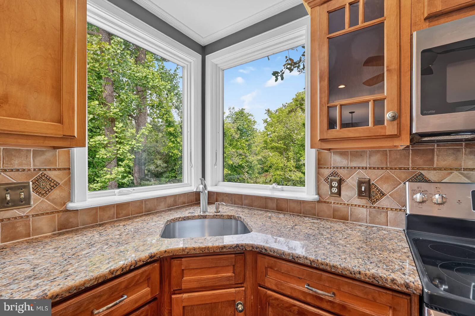 2108 Merrifields Drive Silver Spring, MD 20906 - Photo 14 of 69 a kitchen with granite countertop a sink and a window