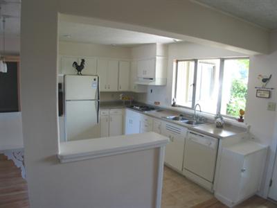 4 Point San Pedro Road, Unit 6 San Rafael, CA 94901 - Photo 4 of 11 a kitchen with stainless steel appliances a sink a stove a refrigerator and cabinets