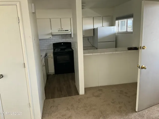 a view of a kitchen from the hallway
