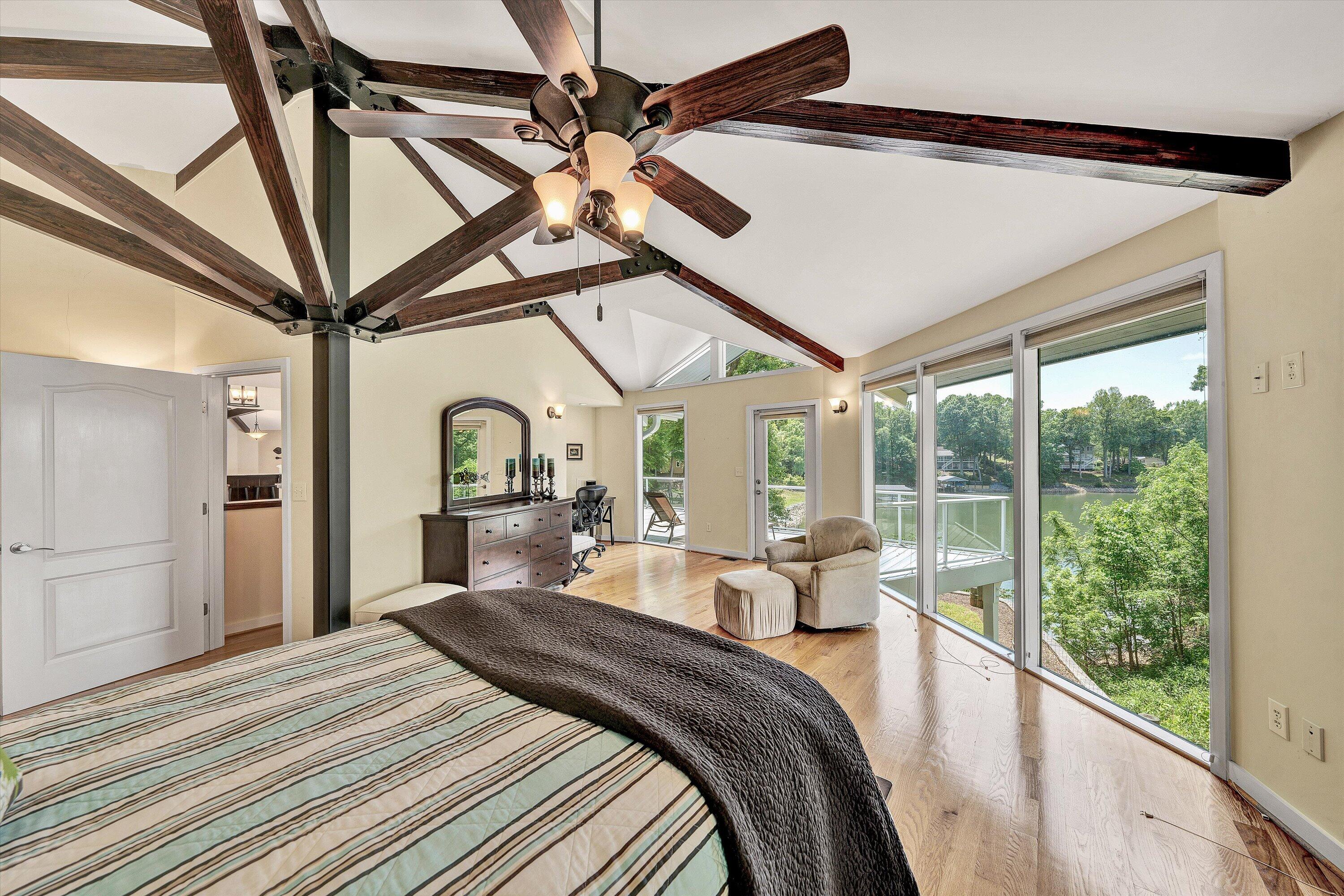 207 Winding Way Union Hall, VA 24176 - Photo 24 of 60 a bedroom with a bed and a large window with a flat screen tv