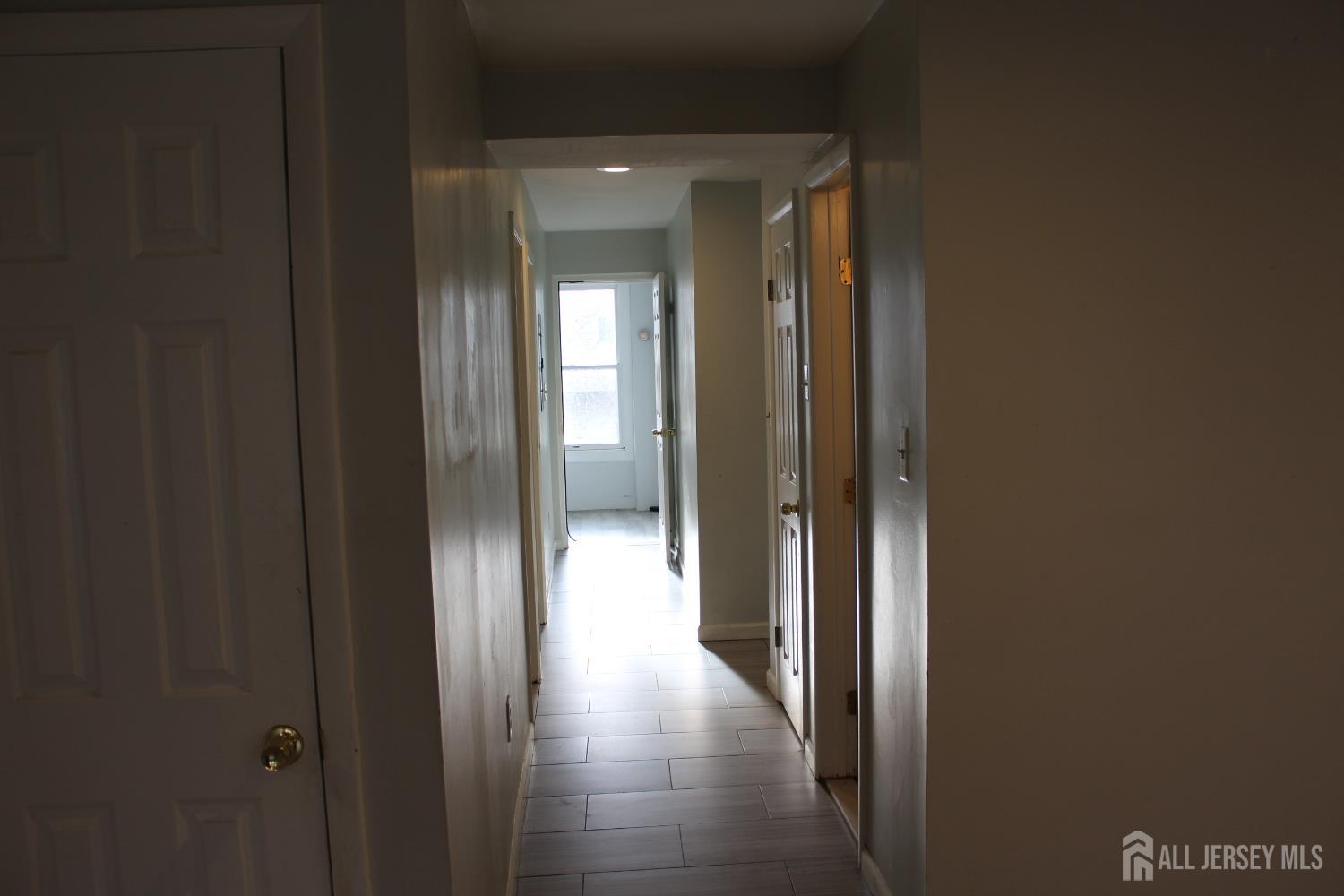 899 Green Street, Unit 1 Iselin, NJ 08830 - Photo 14 of 45 a view of a hallway with wooden floor