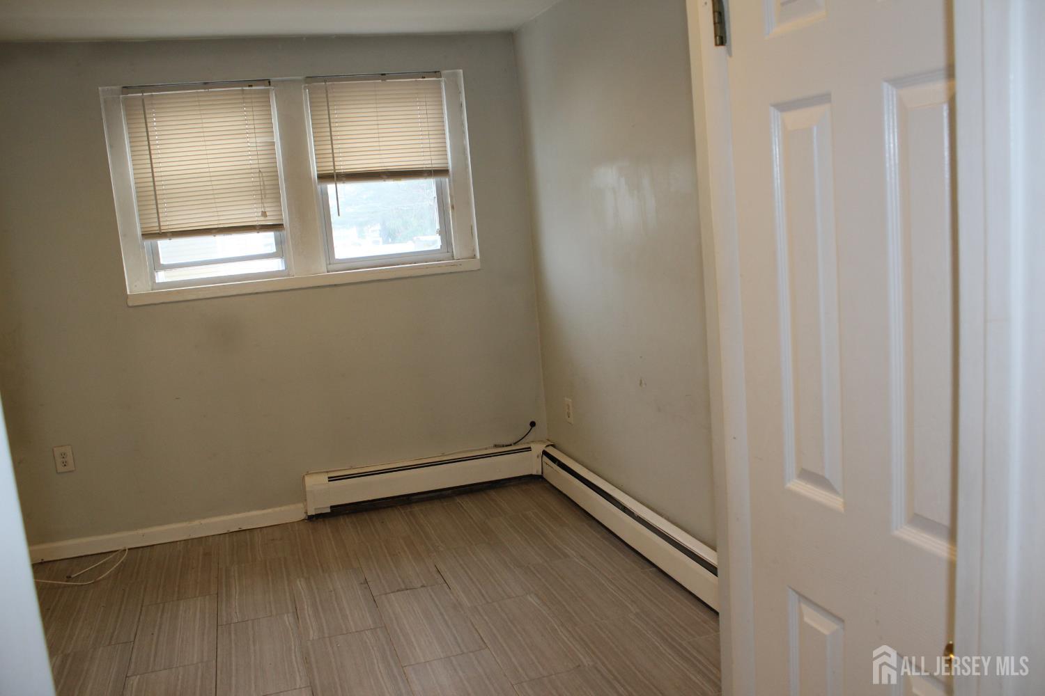899 Green Street, Unit 1 Iselin, NJ 08830 - Photo 17 of 45 an empty room with a window