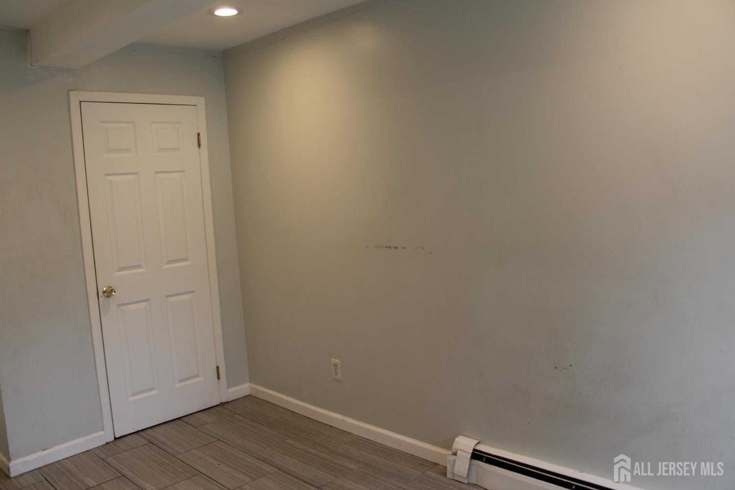 899 Green Street, Unit 1 Iselin, NJ 08830 - Photo 24 of 45 an empty room with wooden floor