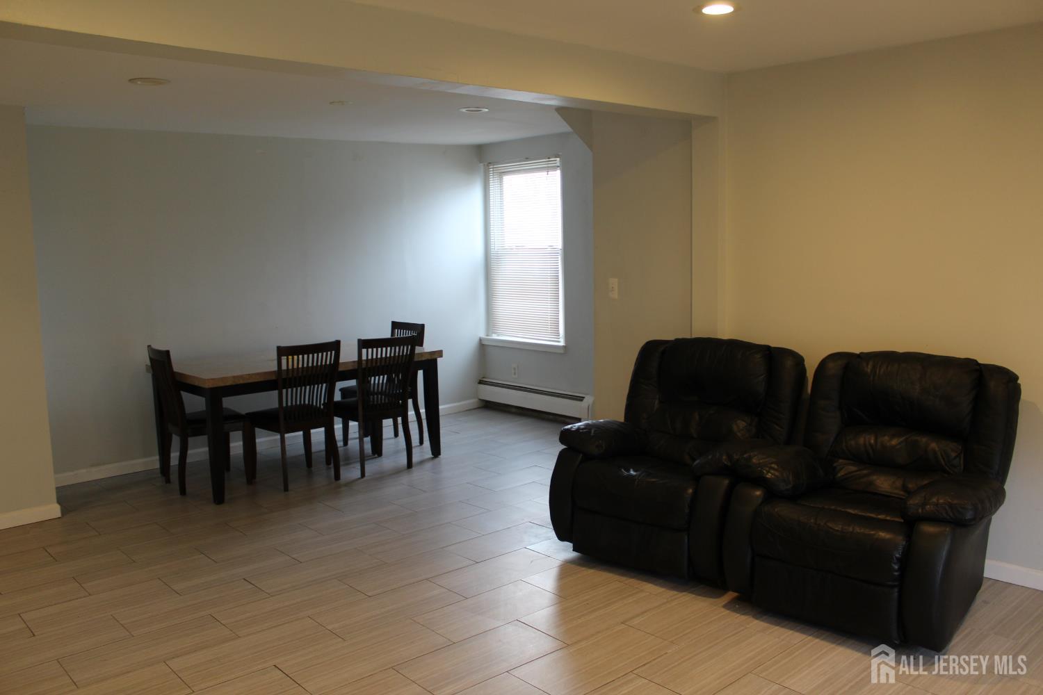 899 Green Street, Unit 1 Iselin, NJ 08830 - Photo 6 of 45 a living room with furniture and a dining table
