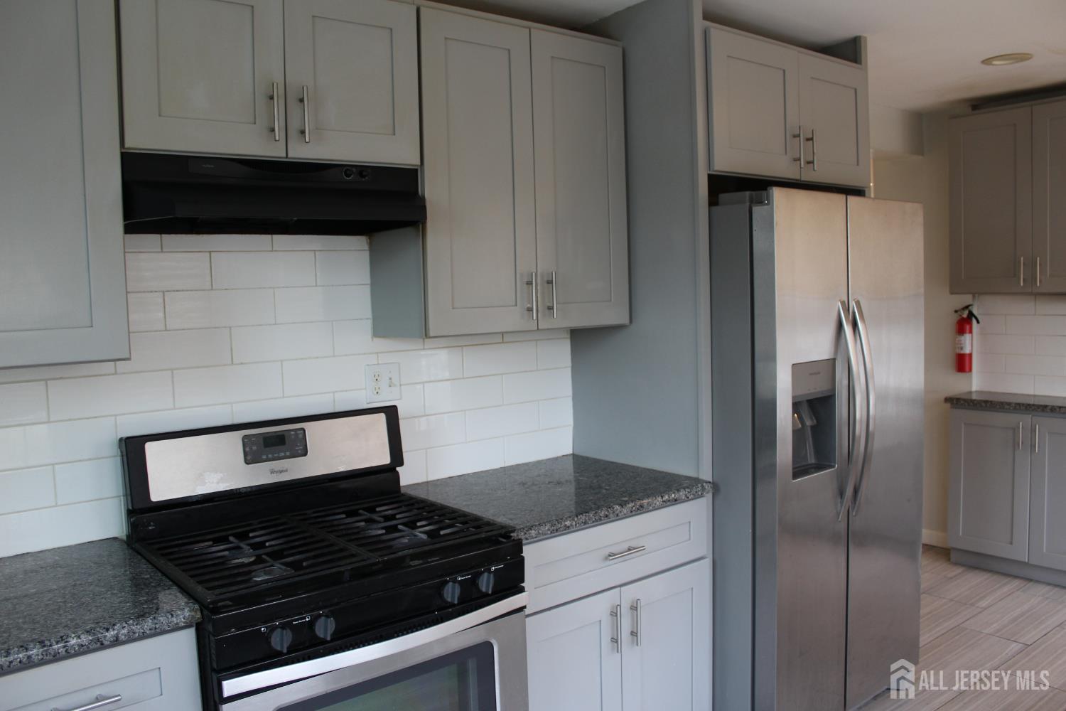 899 Green Street, Unit 1 Iselin, NJ 08830 - Photo 8 of 45 a kitchen with refrigerator and cabinets