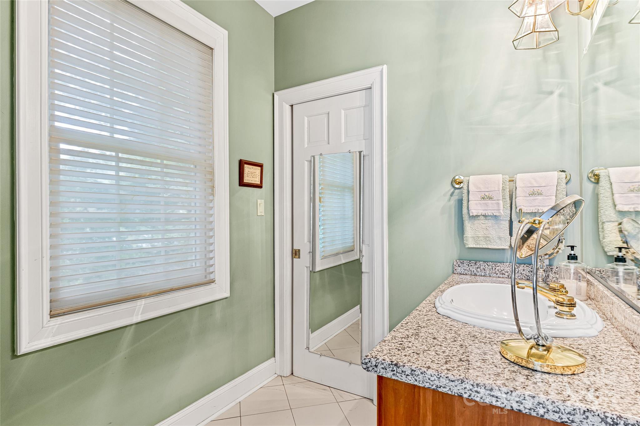 842 Rickel Drive Hendersonville, NC 28739 - Photo 13 of 48 a bathroom with a granite countertop sink and a mirror