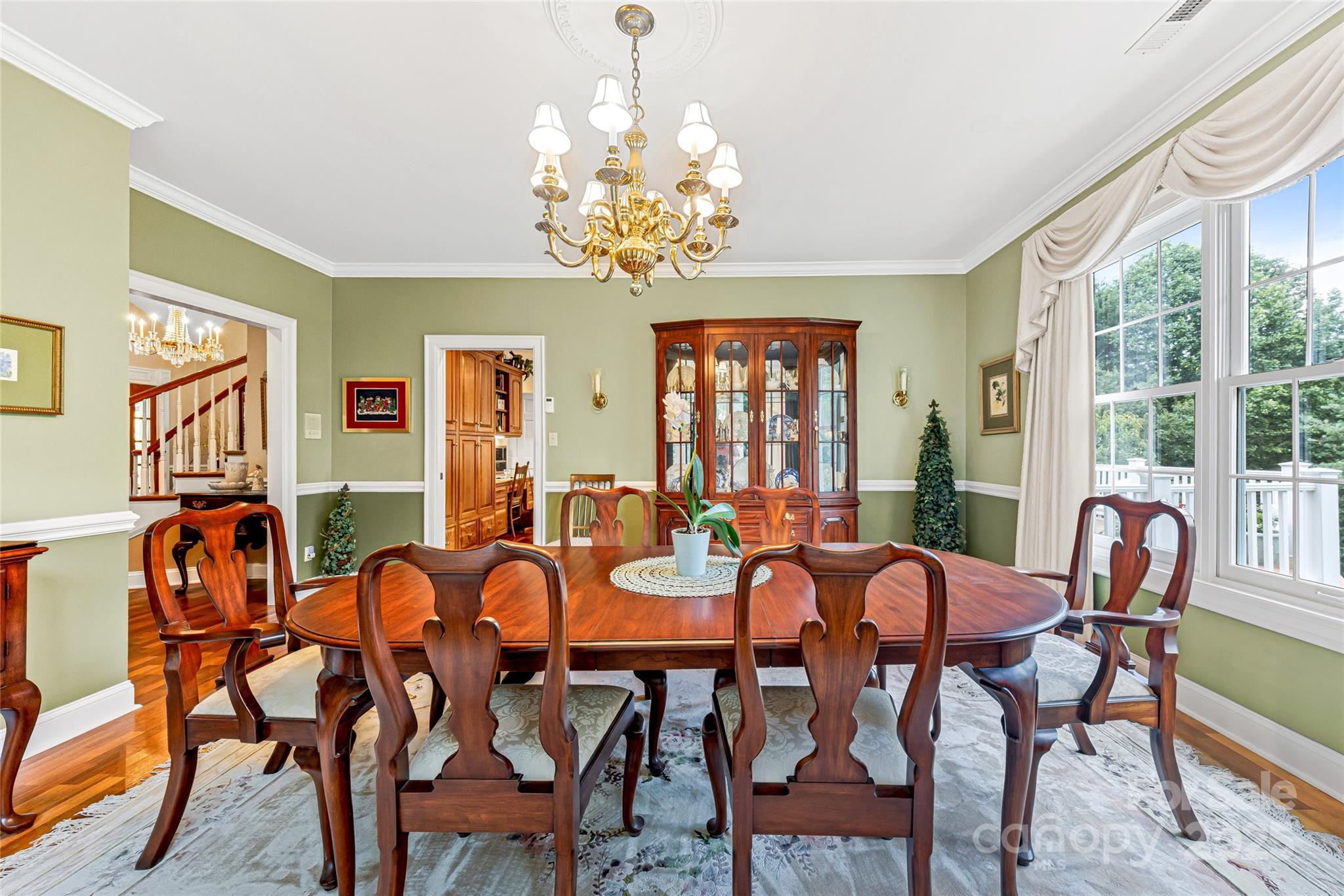 842 Rickel Drive Hendersonville, NC 28739 - Photo 16 of 48 a view of a dining room with furniture a chandelier and large windows