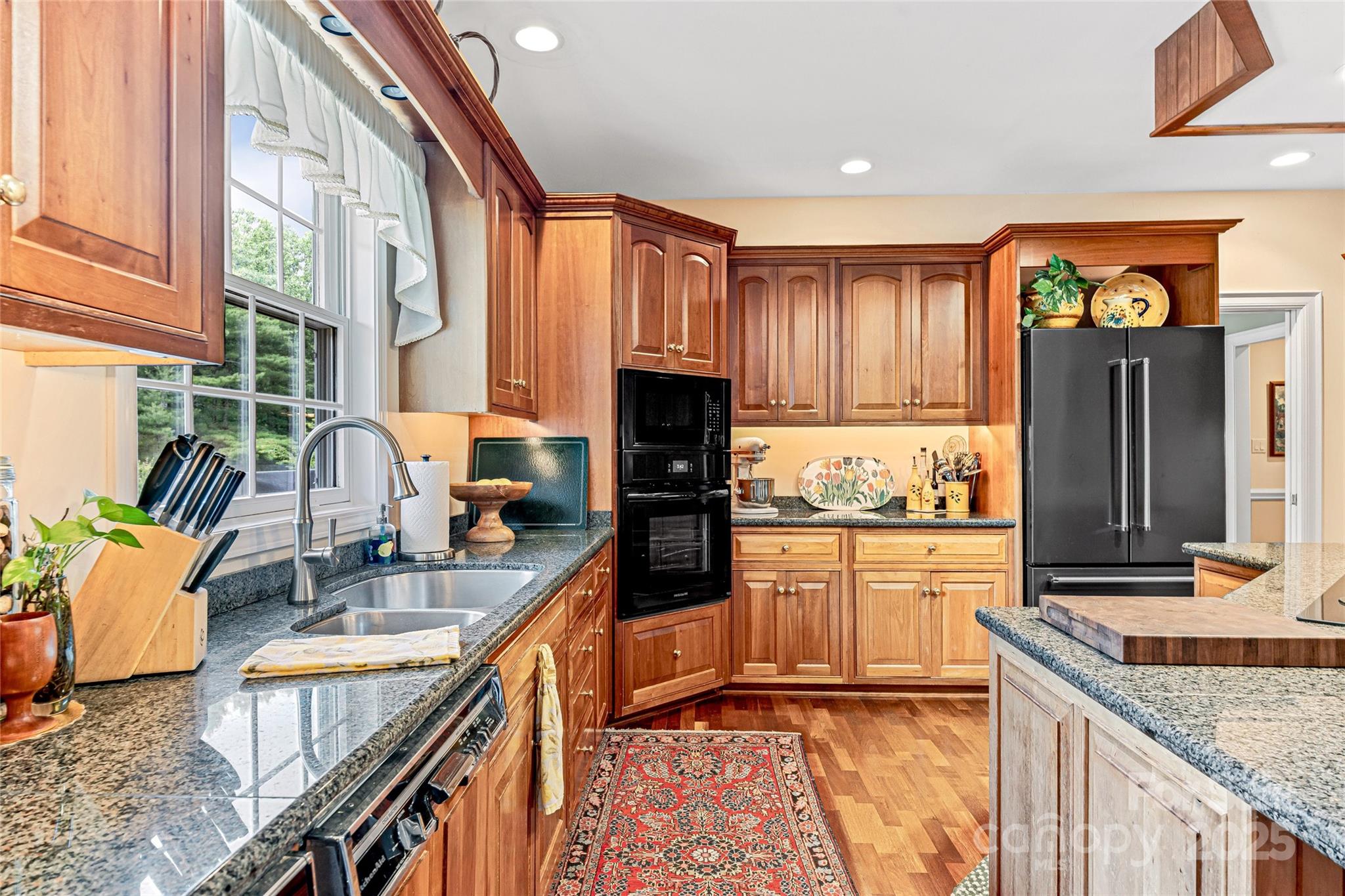 842 Rickel Drive Hendersonville, NC 28739 - Photo 18 of 48 a kitchen with granite countertop a stove a sink and a refrigerator