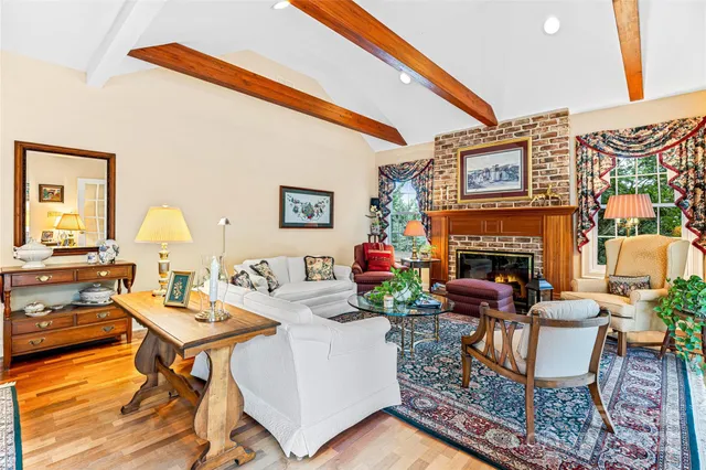 a living room with furniture a fireplace and a table