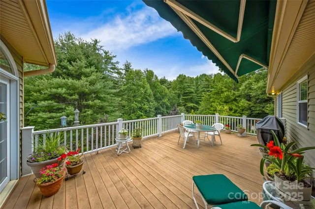 a view of a balcony with furniture and floor to ceiling window