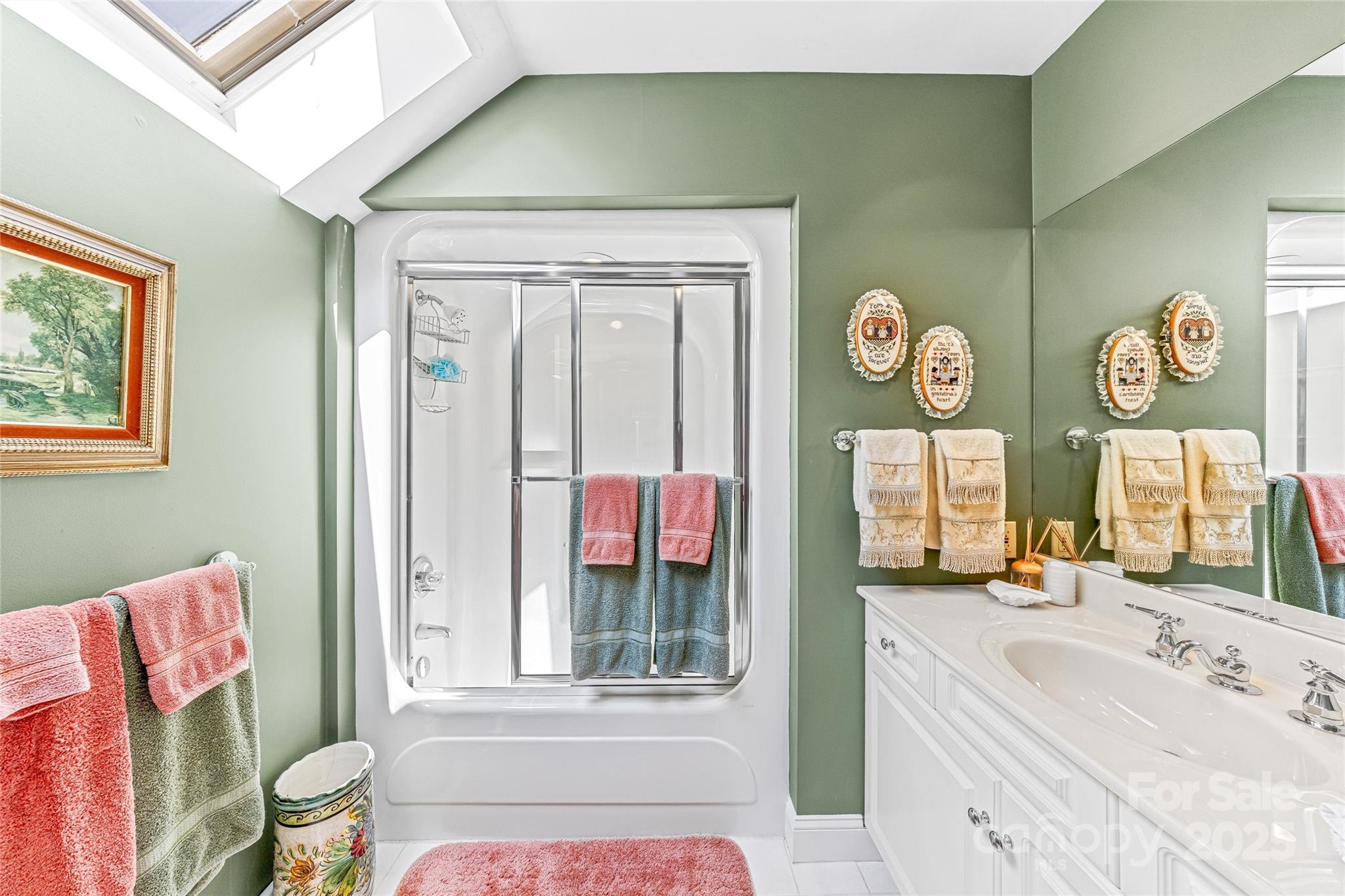 842 Rickel Drive Hendersonville, NC 28739 - Photo 25 of 48 a bathroom with a sink a mirror and a window