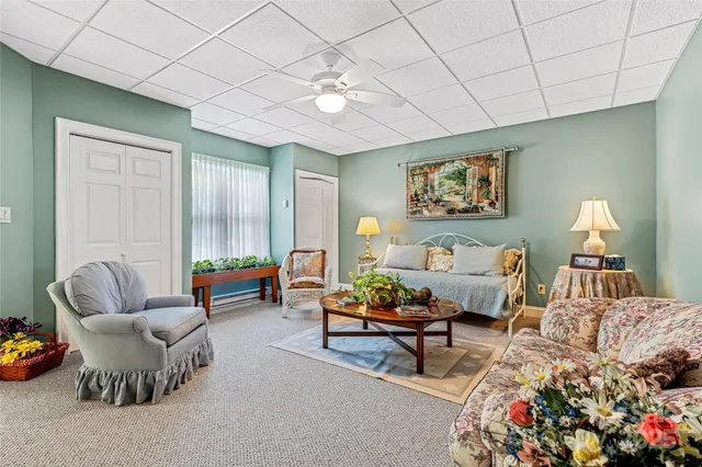 a living room with furniture a table and chairs