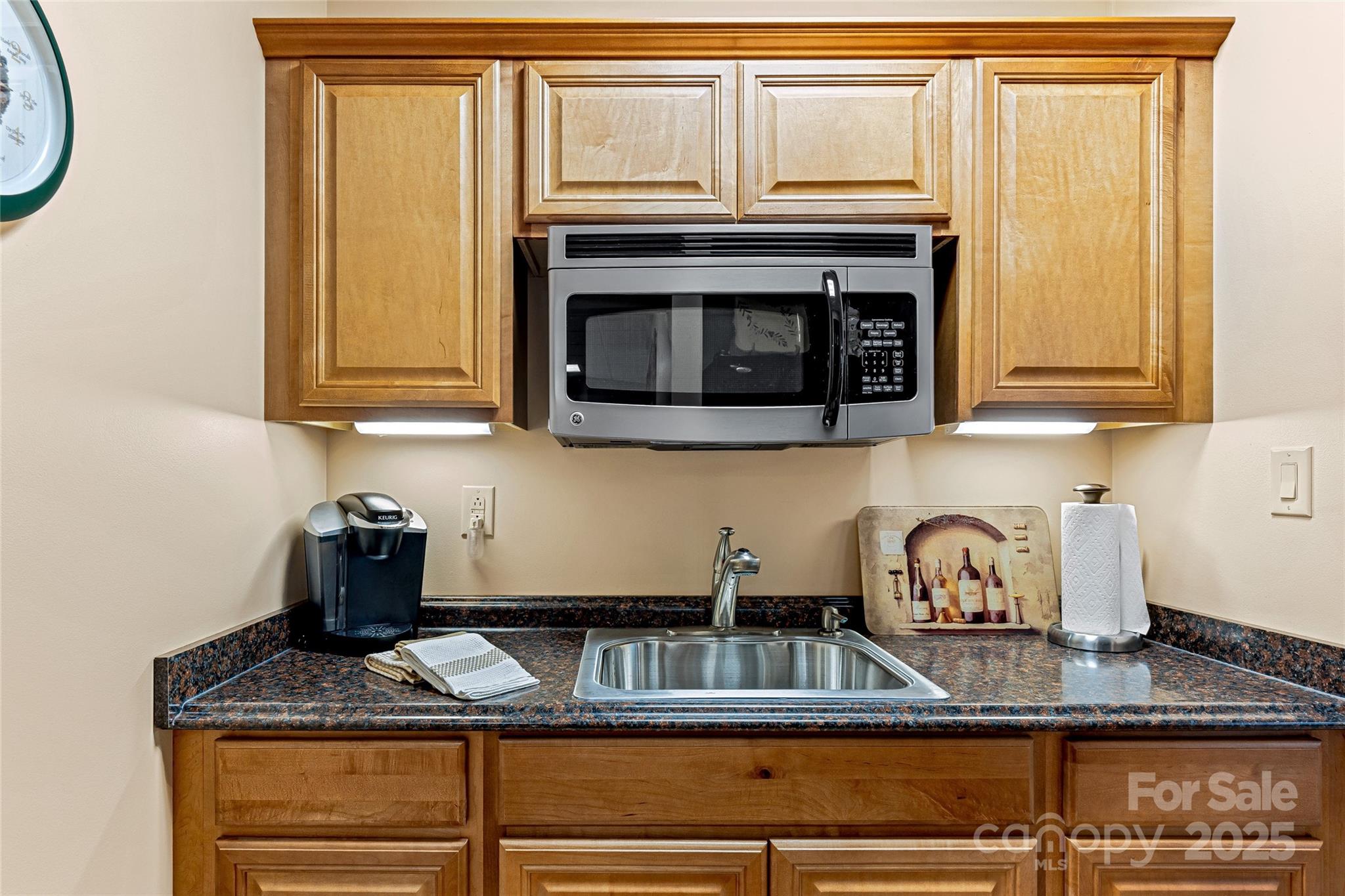842 Rickel Drive Hendersonville, NC 28739 - Photo 36 of 48 a kitchen with granite countertop cabinets stove top oven and microwave