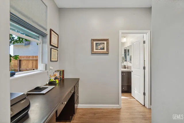 a view of a workspace with furniture and wooden floor
