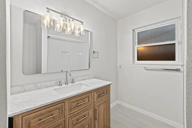 a bathroom with a sink a vanity and a mirror