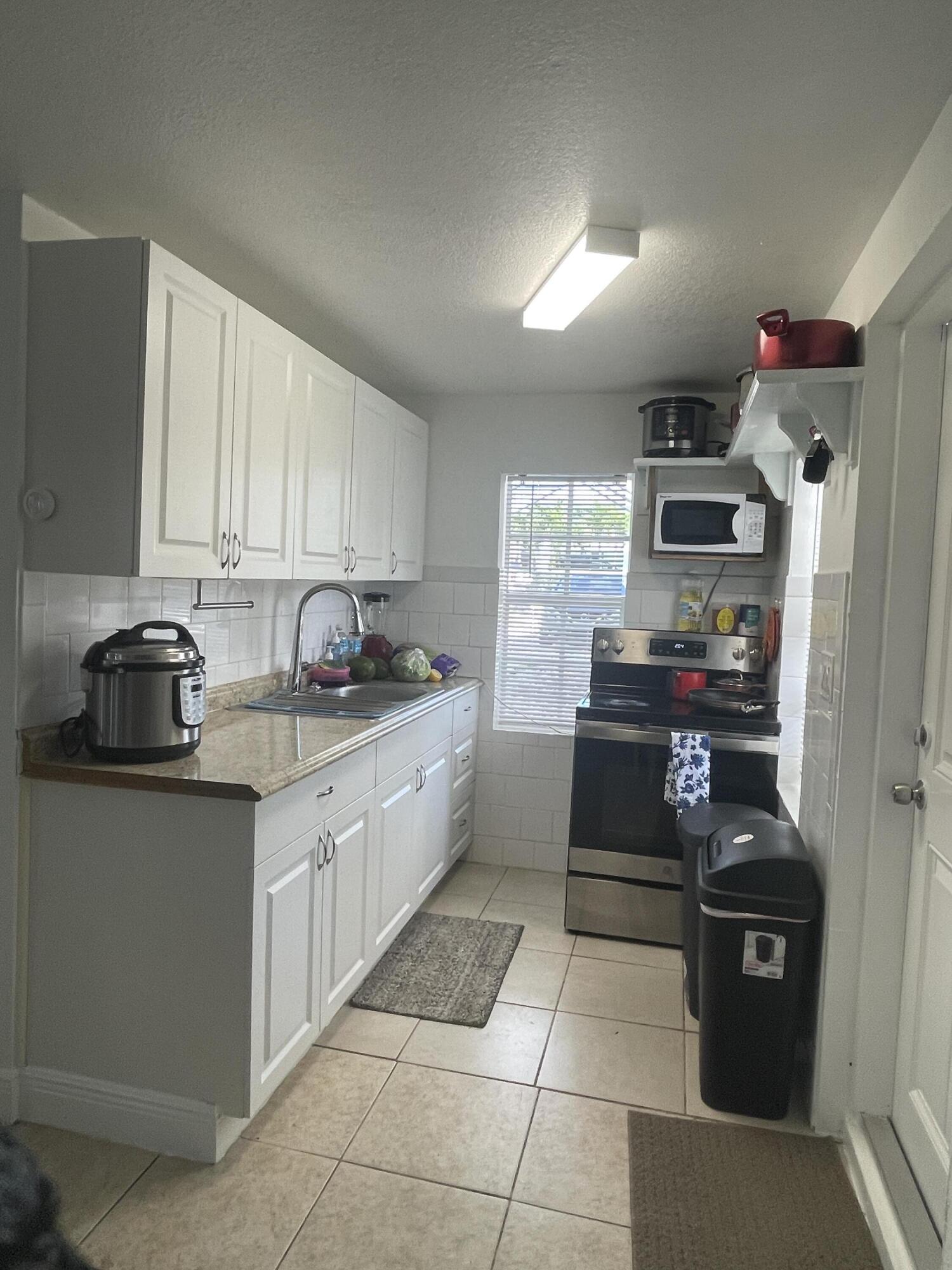 625 73rd Street, Unit AB Marathon, FL 33050 - Photo 17 of 23 a kitchen with stainless steel appliances granite countertop a stove sink and cabinets