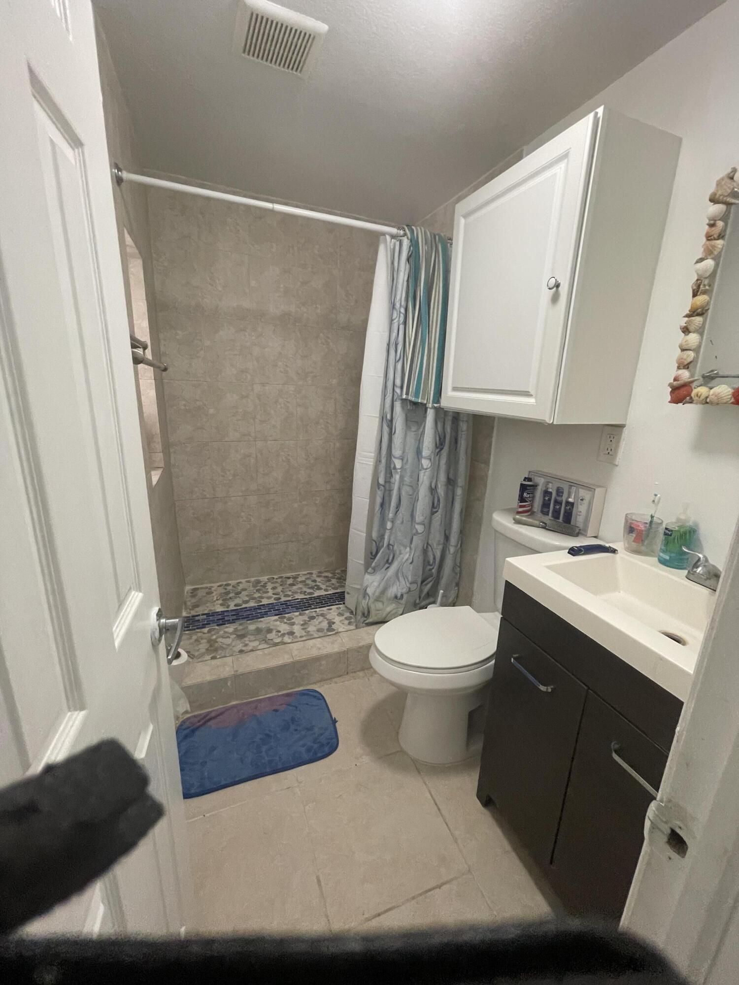 625 73rd Street, Unit AB Marathon, FL 33050 - Photo 7 of 23 a bathroom with a sink a toilet and shower