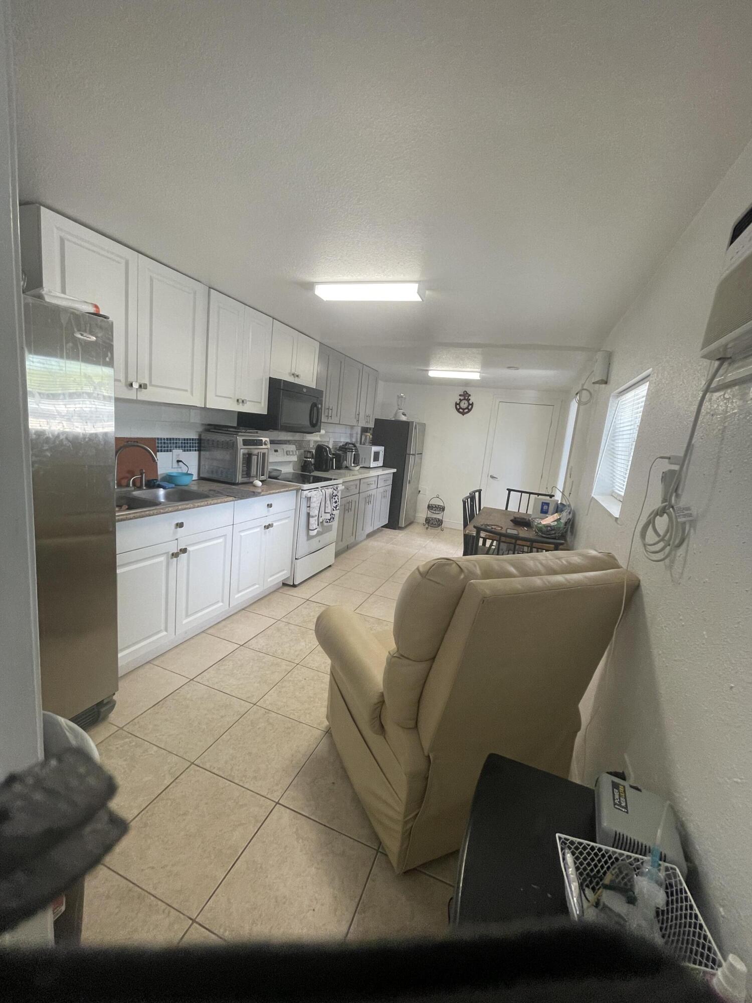 625 73rd Street, Unit AB Marathon, FL 33050 - Photo 9 of 23 a kitchen with stainless steel appliances granite countertop a sink refrigerator and cabinets