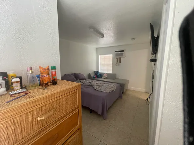 a bedroom with a bed and dresser